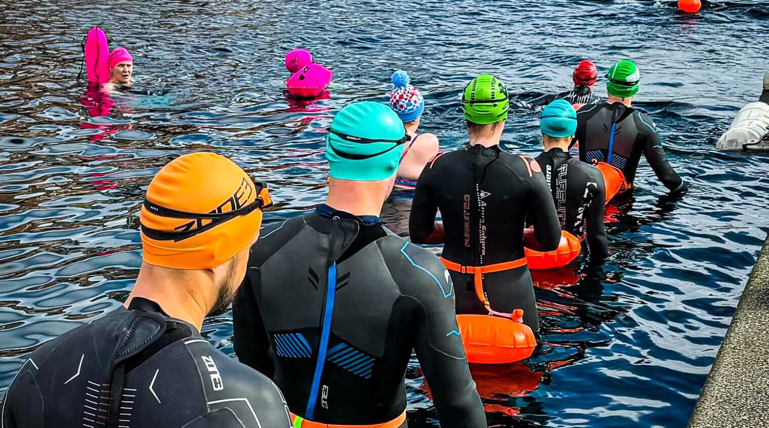 People entering water for open water swimming session